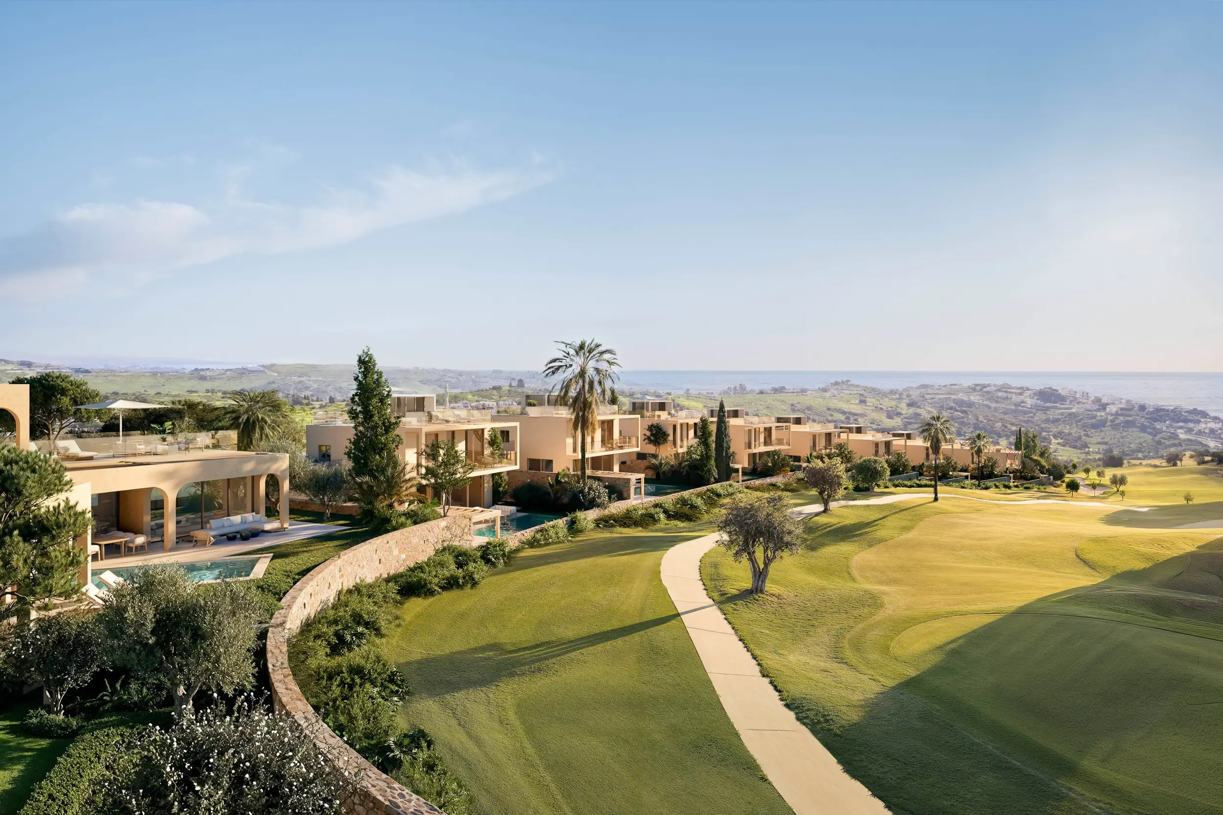 The Amaris villas on the hillside above the fairways, with the Mediterranean beyond
